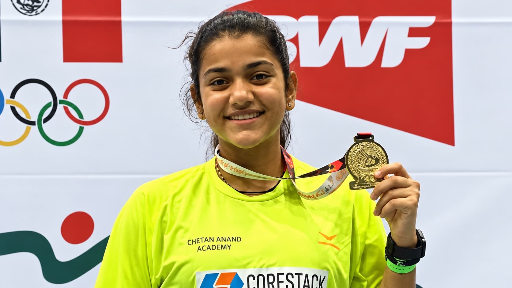 Srivedya Gurazada holding a medal at a BWF tournament